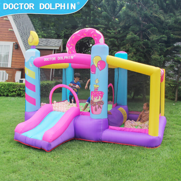 Kids playing inside Candy Castle birthday bounce house with slide and ball pit at party in Aloha Oregon