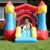 Toddler sliding down Cozy Castle bounce house rental in Beaverton Oregon backyard