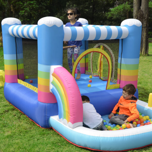 Kids playing in ball pit and bouncing inside colorful rainbow inflatable rental near Portland Oregon