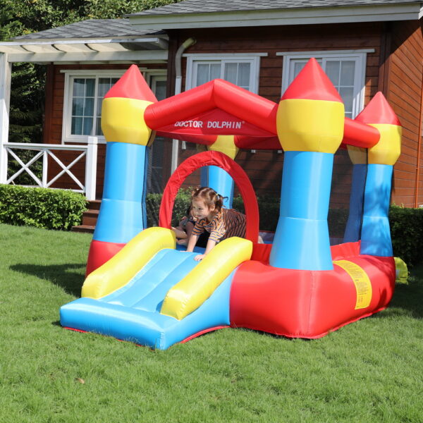 Compact castle bounce house with slide set up on grass for kids party in Beaverton OR