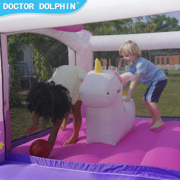 Kids riding inflatable unicorn toy inside pink unicorn bounce house rental in Hillsboro OR