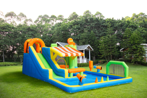 Carnival Splash Park with slide and large water pool set up on backyard grass - inflatable water park rental Portland Oregon