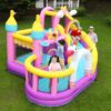 Kids bouncing and playing on dreamy unicorn castle bounce house combo with slide and ball pit in backyard - Portland Oregon rental