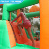 Girl climbing padded wall inside enchanted castle splash bouncer with mesh safety netting - inflatable rental Portland