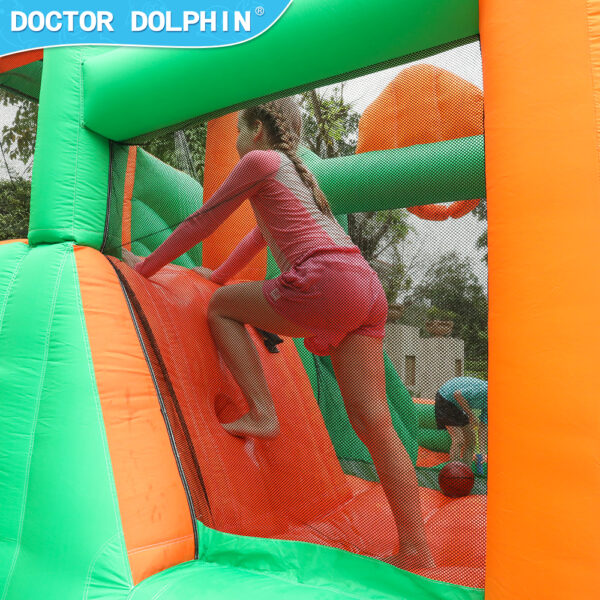 Girl climbing padded wall inside enchanted castle splash bouncer with mesh safety netting - inflatable rental Portland