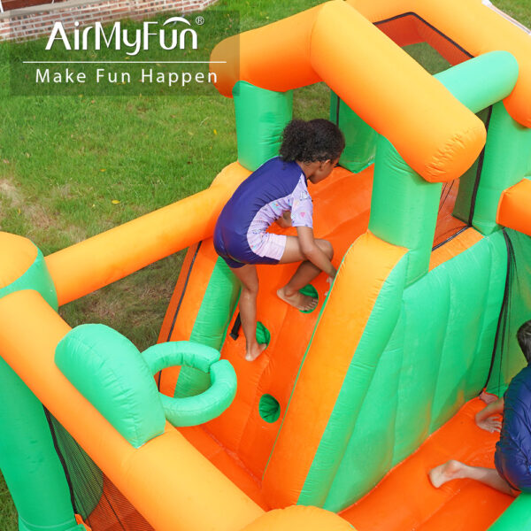 Boy climbing padded climbing wall inside Jungle Castle Splash Bouncer inflatable rental - fun party activity for kids