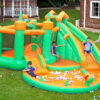 Kids playing on Jungle Castle Splash Bouncer with slide ball pit and bounce area in backyard - water slide rental Portland Oregon