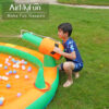 Boy spraying water cannon on Jungle Castle Splash Bouncer inflatable water park - water slide rental Portland