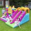 Children sliding down double slides on princess unicorn bounce house combo rental in Portland Oregon