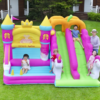 Kids bouncing and sliding on princess castle unicorn inflatable with double slide - bounce house rental Beaverton