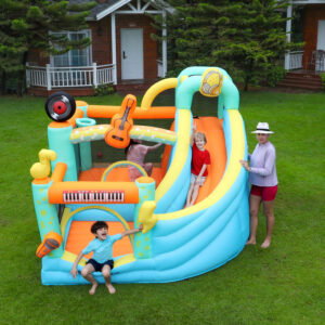 Kids playing on rock star music themed bounce house with slide in backyard - bounce house rental Portland Oregon