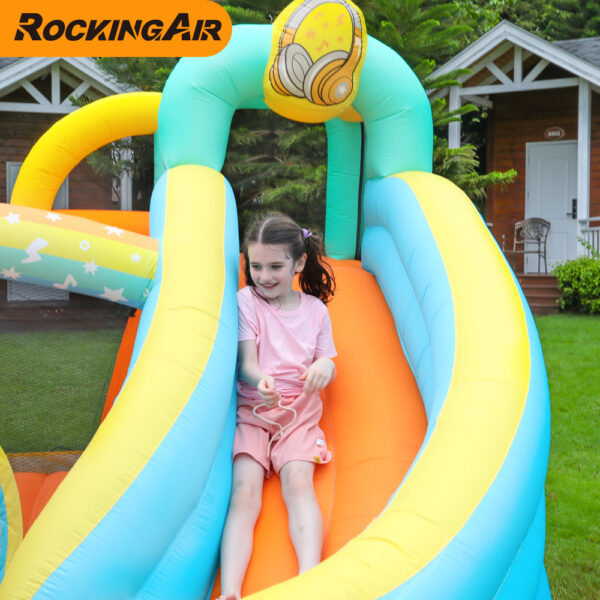 Girl sliding down the colorful slide on rock star bouncer combo rental in Beaverton Oregon