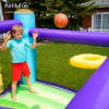 Boy playing basketball inside Summit Climber bounce house rental - built-in hoop for kids party fun