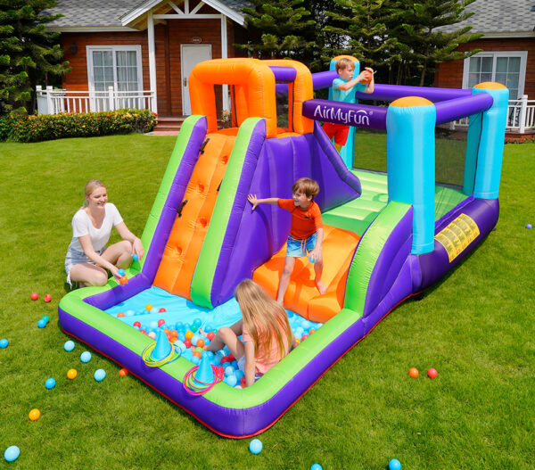 Kids playing on purple and green bounce house combo with slide ball pit and ring toss - bounce house rental Beaverton Oregon